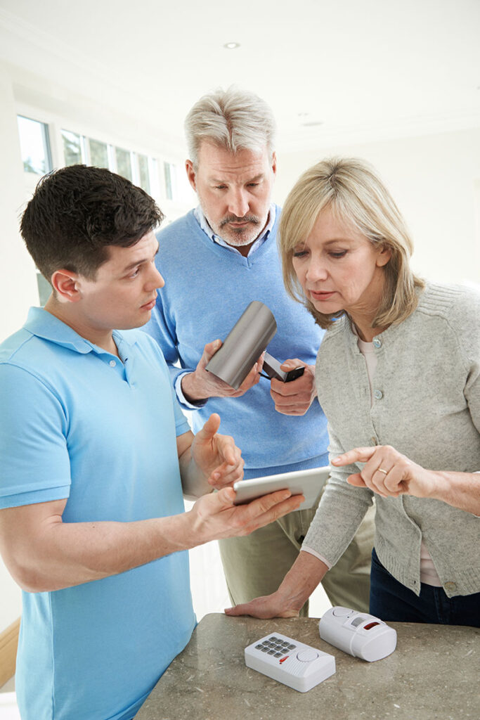 Alarm Installer Consulting with Client